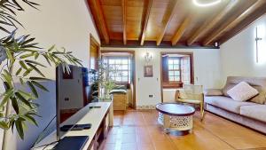 a living room with a couch and a table at Finca Paraiso Casa Rural Tenerife Ecoturismo in Las Lagunas