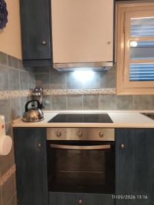 a kitchen with a sink and a stove top oven at Villa Galazia in Megalochori +37 photos