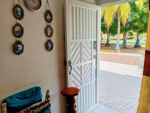 an open door to a patio with a clock at Cabaña Villa Gabi in San Antero