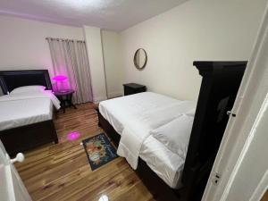 a bedroom with two beds and a table with a lamp at Spacious 3BR Niagara Stay + Backyard in Niagara Falls +9 photos