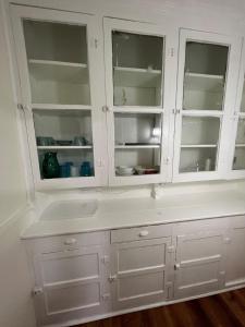 a kitchen with white cabinets and a sink at Spacious 3BR Niagara Stay + Backyard in Niagara Falls