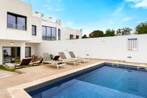 a swimming pool in front of a house at JB RiaMar l by Meditrust in Alvor
