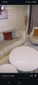 a living room with a couch and a table at Villa n 5 in Sidi Daoud