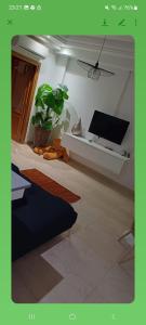 a living room with a flat screen tv on a wall at Villa n 5 in Sidi Daoud