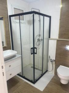 a glass shower in a bathroom with a toilet at Villa n 5 in Sidi Daoud