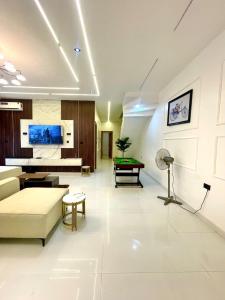 a living room with a couch and a pool table at Prince-Coll apartment in Lagos
