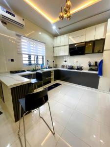 a large kitchen with a table and chairs in it at Prince-Coll apartment in Lagos