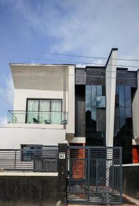 a house with a black gate in front of it at Prince-Coll apartment in Lagos