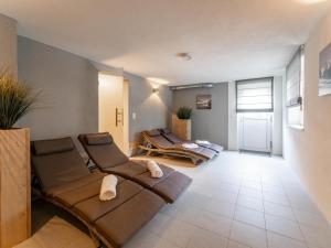a living room with a couch and chairs in it at Haus Aifnerspitze in Kauns