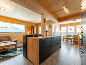 a kitchen with a large island in a room at Lachende Eule in Hohentauern