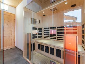 a walk in wine cellar with a glass door at Lachende Eule in Hohentauern +39 photos