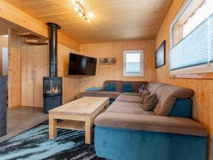a living room with a couch and a fireplace at Lachende Eule in Hohentauern