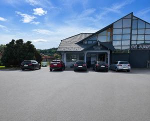 a parking lot with cars parked in front of a building at Apartmani Stevanović in Zvornik