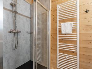 a shower in a bathroom with wooden walls at Rattendorf 11B in Rattendorf