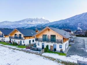 a home in the mountains with snow on the ground at Rattendorf 11B in Rattendorf