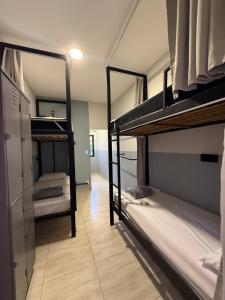 a room with two bunk beds and a hallway at São Hostel in São Roque