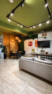a restaurant with a couch in the middle of a room at São Hostel in São Roque