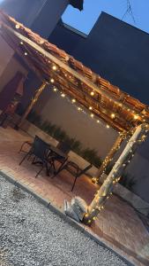 a wooden pergola with lights on a patio at São Hostel in São Roque
