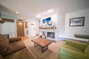a living room with a couch and a fireplace at Flying Dutchman 1115 by SummitCove Lodging in Colorado in Keystone