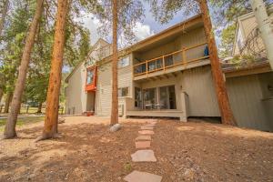 a house with a balcony in the middle of trees at Flying Dutchman 1115 by SummitCove Lodging in Colorado in Keystone