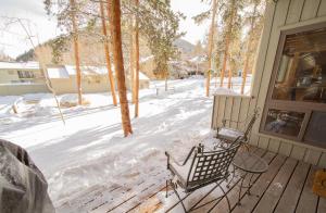 a bench sitting on a porch in the snow at Flying Dutchman 1115 by SummitCove Lodging in Colorado in Keystone