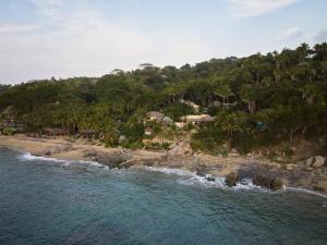 an aerial view of a beach with palm trees at La Joya Sayulita in Sayulita