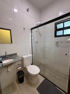 a bathroom with a toilet and a shower and a sink at São Hostel in São Roque