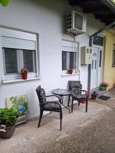 a patio with a table and two chairs and a window at Eid in Mostar