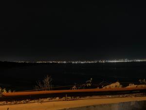 a view of the ocean at night at Hostal Belletini in Manta