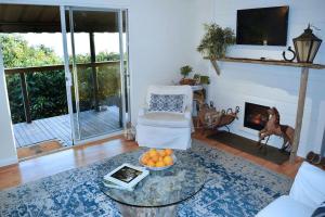 a living room with a table and a fireplace at The Tack Room in Naples