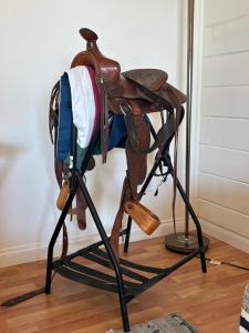 a stand with a backpack on top of it at The Tack Room in Naples +8 photos