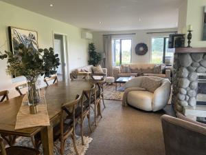 a living room with a table and a fireplace at Yuki's Chalet - Terrace Downs in Windwhistle