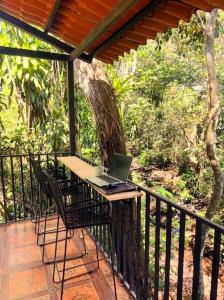 a laptop computer sitting on a table on a porch at Blue Palm Bed & Breakfast in Barrio Jesús