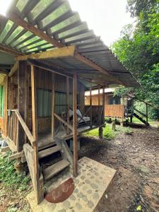 a wooden house with awning on top of it at hot springs jungle in Shintuya