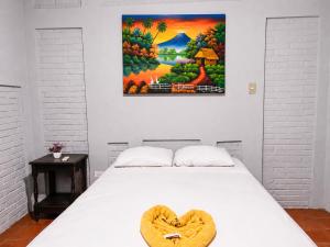 a bedroom with a bed with a wooden heart on it at hotel Oasis Managua Experience - HOME in Managua +24 photos