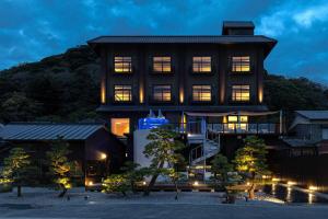 a large building with its lights on at night at 中尾甚六Hotel in Karatsu
