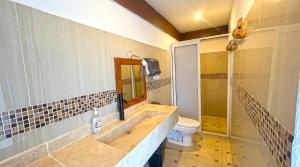 a bathroom with a sink and a toilet at Casa ka'an in Isla Mujeres