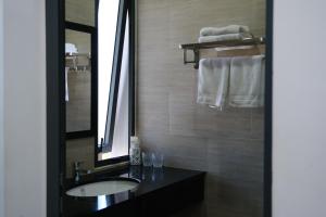 a bathroom with a sink and a mirror and towels at Cloudy Homestay Hoi An in Hoi An +92 photos