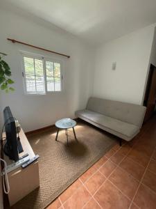 a living room with a couch and a table at Rdj A in Porto Moniz