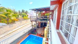 a swimming pool on the balcony of a building at Casa ka'an in Isla Mujeres