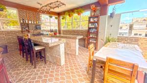 a kitchen with a table and chairs and some windows at Casa ka'an in Isla Mujeres