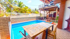 a table and chairs next to a swimming pool at Casa ka'an in Isla Mujeres +20 photos