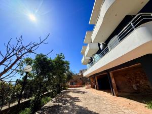 an empty street next to a building at Davide Rooms in Sarandë +66 photos