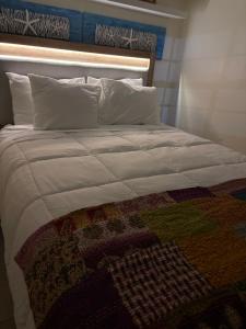a large bed with a blanket and pillows on it at LasPalmas Beach Rentals,3 in Bradenton Beach +38 photos