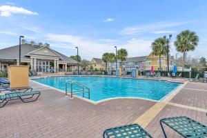 a swimming pool with chairs in a resort at Casa Santa Maria in Kissimmee