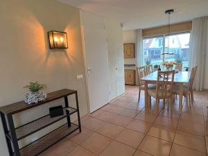 a kitchen and dining room with a table and chairs at Park De Markol Tureluur 13 in Lemmer