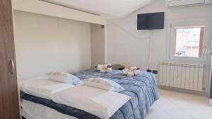 a bedroom with a bed with two stuffed animals on it at Ca’ Marea by Ca-Sa Check in Chioggia
