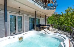 a hot tub on the patio of a house at Pet Friendly Apartment In Matulji in Matulji