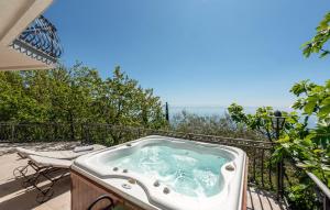 a jacuzzi tub on the balcony of a house at Pet Friendly Apartment In Matulji in Matulji