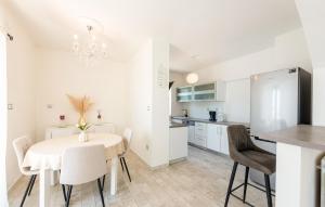 a kitchen and dining room with a table and chairs at Pet Friendly Apartment In Matulji in Matulji